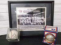 Lot overview showing framed photo, autographed ball in cube, Northern League ball in box