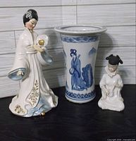 Three items: Josef Originals geisha figurine, Bombay Co. blue-white vase, Ardalt kneeling musician figurine