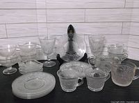 Group shot showing all clear pressed glass pieces including goblets, sherbets, cups, plates, trinket dishes, creamer and sugar