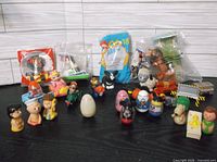 Group shot of all items including Peanuts figures, wobble eggs, sealed Happy Meal toys, vehicles and accessories