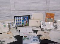 Overall view of first day covers, Bugs Bunny pane, Scott catalog and loose stamps