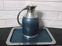 Pitcher on tray with stopper inserted