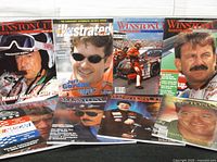 Eight racing magazines fanned out, full lot overview