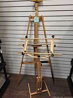 Front view of both wooden adjustable easel and needlework stand