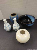 Group shot of all five pieces: cloisonné vase, crane bowl, two blue-white bud vases, ivory bud vase