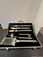 Open case showing all stainless steel tools secured in straps