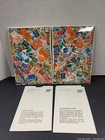Two sealed stamp packs and two bilingual info sheets