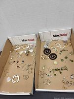 overview of two trays containing many earrings