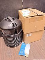 Full view of air purifier, box of filters, brochure