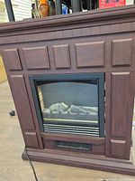 Front view of electric fireplace showing mantel and firebox