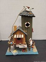 Front view of wooden fishing camp decor showing tower and cabin
