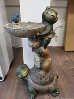 Full view of composite frog, rabbit, turtle bird bath statue