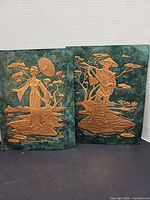 Front view of both copper relief panels side by side