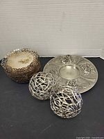 Overall lot: stacked footed dishes, decorative balls, pewter plate
