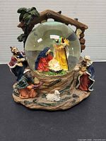 Front view showing entire musical nativity globe with figures