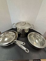 Overall group of stockpot, two fry pans and sauté pan with lids