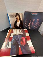 Front covers of Springsteen Darkness notebook, Eagles Desperado, Springsteen Born in the U.S.A.