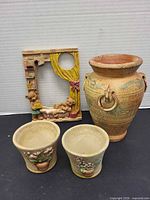 Group shot of vase, two mini pots, and resin picture frame