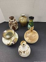 All six pottery vases grouped together
