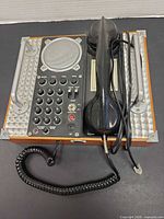 Top view of Spirit of St. Louis speaker telephone showing handset, keypad, speaker grille, and wood case