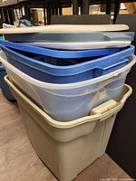 stack of assorted storage totes and lids