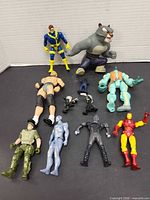 Group shot of all ten figures on black surface