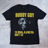 Full front view of black T-shirt with Buddy Guy graphic and text