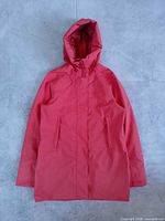 Front view of orange Helly Hansen hooded rain jacket laid flat