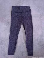 Full view of grey high-rise leggings laid flat
