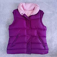 Full view of purple side with pink lining, pockets and front closure visible