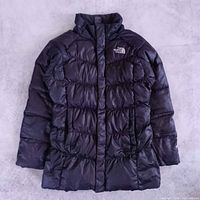 Front view of black The North Face 550-fill girls jacket