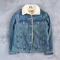 Front view of blue sherpa-lined denim jacket