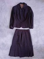 Full view of jacket and skirt laid flat