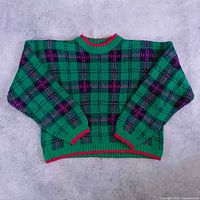 Full view of front of sweater laid flat