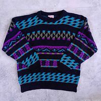 Full view of sweater front displaying geometric pattern and overall condition