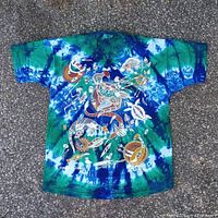 Front view of tie-dye Churinga T-shirt displaying Indigenous artwork