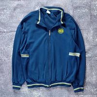 Front view of entire Nike track jacket showing overall condition, color, style and zipper