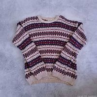 Full view of front of sweater showing pattern and overall condition