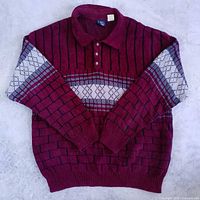 Full front view of burgundy geometric knit sweater with collar and ribbed trim