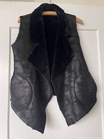 Front view leather side showing draped collar and pockets