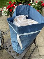 Blue storage bag containing white duvet