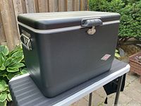 Front and side view showing black steel exterior, latch, and handles
