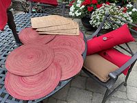 Placemats and cushions displayed on patio table and chair