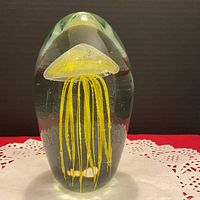 Front view of glass sculpture showing yellow jellyfish