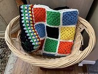 Blanket folded inside wicker basket