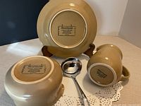Bottom marks of plate, bowl and creamer showing Hearthside Japan stamp plus ladle