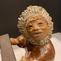 Close-up of glazed terracotta Inuit face and hood
