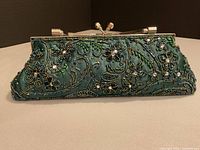 Front view showing green satin body with intricate bead and sequin floral design
