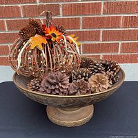 Bowl filled with pinecones and twig pumpkin