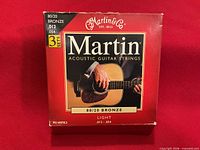 Front of Martin acoustic guitar strings box, 80/20 bronze light, three-set packaging